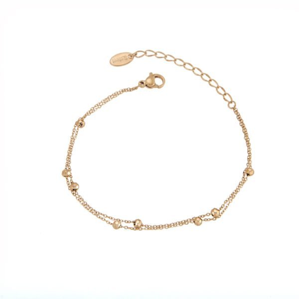 Bracelet chaîne fine with small geometric beads en or rose. Élégance et sophistication pour toutes occasions.